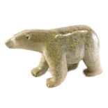 An Inuit carved serpentine stone polar bear, by Ottochre Ashoona, 34cm long.