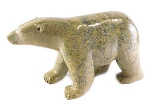 An Inuit carved serpentine stone polar bear, by Ottochre Ashoona, 34cm long.