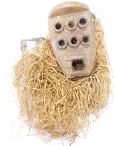 A Grebo (Kru) six eyed warrior mask with raffia beard and cloak, Liberia, approximately 50 years old