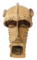 A Kran Old Warrior mask with bells, Liberia, approximately 100 years old, 44cm high.