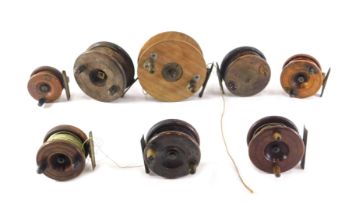 A collection of various mahogany and brass fishing reels, the largest 13cm diameter, the smallest 6c