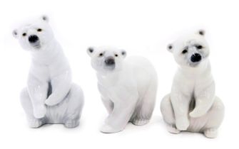 Three Lladro porcelain figures, modelled as polar bears in varying poses, the largest 12cm high.
