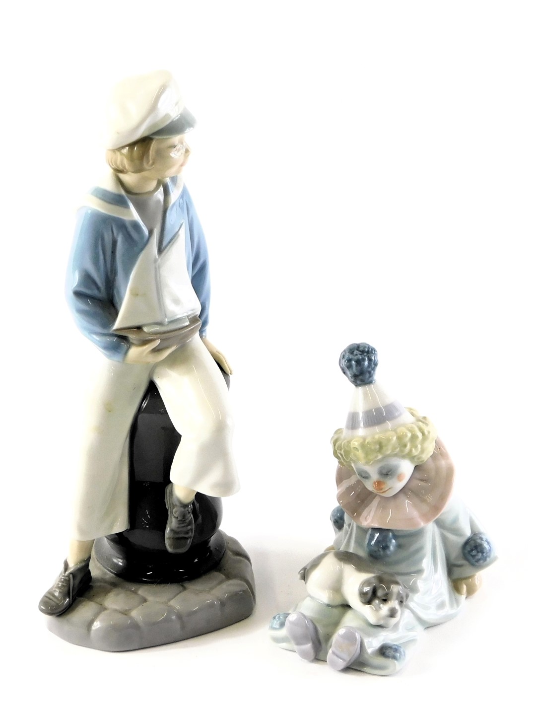 Two Lladro porcelain figures, modelled as a young boy seated holding pond yacht, printed marks, 24cm