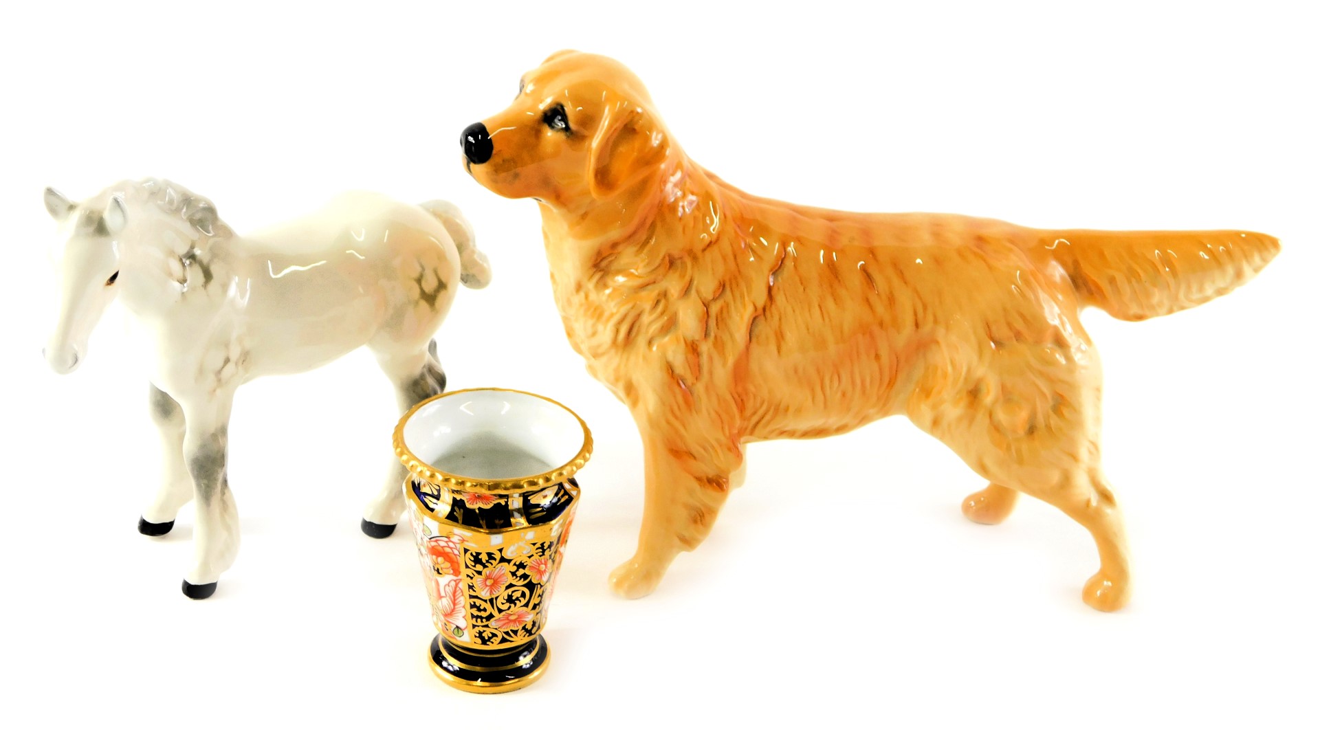 A Beswick pottery figure modelled as a golden retriever, printed marks, 14cm high, together with a d