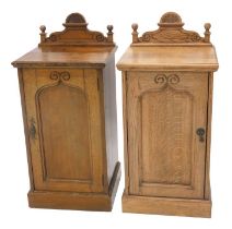 A pair of Edwardian oak pot cupboards, with raised backs, Gothic panelled doors, on plinths, 40cm wi