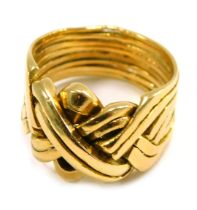 A puzzle ring, of eight layered design, yellow metal unmarked believed to be 18ct gold, ring size U,