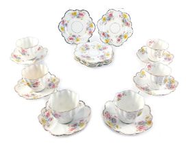 A late 19thC porcelain tea service, printed and painted with coloured flowers, to include six cups,