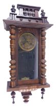 A late 19thC Vienna wall clock in walnut case, the dial with pressed metal centre and paper chapter