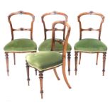 A set of four Victorian walnut aesthetic design balloon back dining chairs, with serpentine seats an