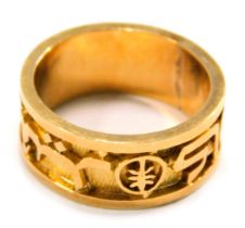 A wedding band, designed with Arabic writing, symbols and numbers, the yellow metal band stamped 18k