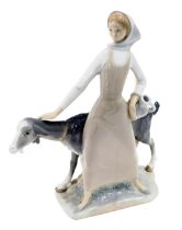 A Lladro porcelain figure modelled as a young lady holding vase beside goat, printed marks, 28cm hig