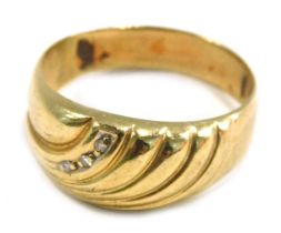 A 9ct gold dress ring, of swirl design set with three tiny diamonds, ring size R½, 2.7g all in.