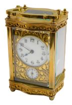A late 19thC brass carriage clock, the circular enamel dial bearing Arabic numerals, subsidiary seco