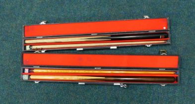 Two snooker cues, cased.