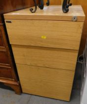 A Paragon three drawer filing cabinet, in simulated oak finish, 86cm high, 44cm wide, 62cm deep.