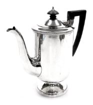 A George VI silver coffee pot, of cylindrical footed form, Walker and Hall, Sheffield 1947, 18.36oz.