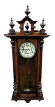 A late 19thC mahogany cased Vienna wall clock, circular brass dial with enamel chapter ring bearing