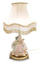 A Capodimonte porcelain figural table lamp, modelled as an 18thC lady seated reading a book to a chi