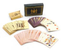 Two packs of early 20thC Worshipful Company of Playing Cards playing cards, contained in a green mor