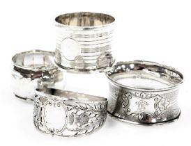 A George V silver napkin ring, with engine turned decoration, Birmingham 1930, two further silver na