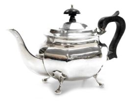 A silver teapot, of octagonal form, raised on four scroll feet, hallmarks worn, 12.70oz.