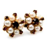A pair of 9ct gold garnet and seed pearl earrings in a floral design, 3.6g.
