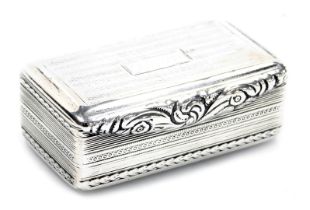 A George IV silver snuff box, the hinged lid with dedicated inscription and scroll swag thumb piece,