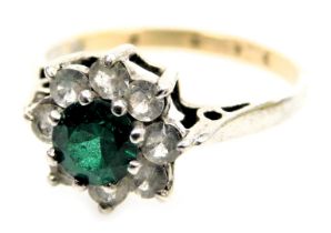 A 9ct gold and silver flowerhead cluster ring, set with a central green stone within a petalled bord