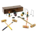 An early 20thC vintage table croquet set, with four mallets and balls, five hoops and two markers, o