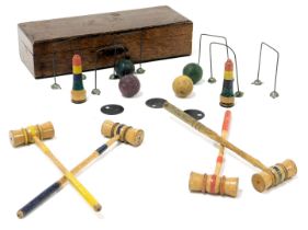 An early 20thC vintage table croquet set, with four mallets and balls, five hoops and two markers, o