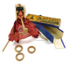 A late 19thC game of Aunt Sally, with a painted wooden and fabric bound figure, hoops, poles and pip