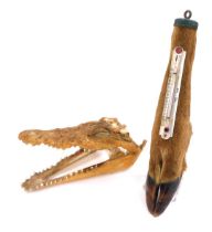 A Caiman skull, together with an American thermometer, mounted on an antelope's hoof, 29cm high. (2)
