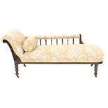 A Victorian mahogany framed chaise longue, with a galleried side, upholstered in brown and white fol