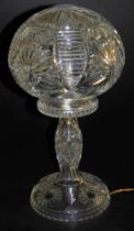 A mid-century cut glass table lamp, with a cut glass shade, engraved with flower heads, 39cm high.