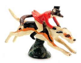 An LL Mascots cold painted brass car mascot, modelled as a fox in hunting attire atop a hound, 13cm