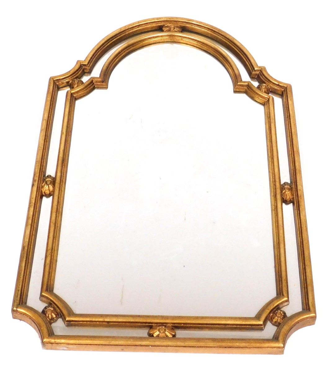 A Regency style gilt wood and gesso wall mirror, with a domed top, 107cm high, 68cm wide.