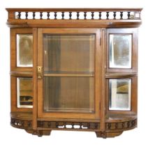 A Victorian oak wall mounted display cabinet, with a galleried top over a central glazed door, inset