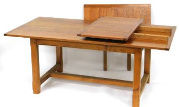A late 20thC oak draw leaf dining table, with a four plank top, raised on canted square legs united