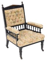 A Victorian ebonised library chair, upholstered in button back floral fabric, raised on turned legs