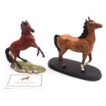 A Beswick matt brown pottery figure of a horse, modelled with its head and front left leg raised, ra