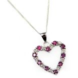 A 9ct white gold ruby and diamond heart shaped pendant, on a ring suspension, and fine curb link nec