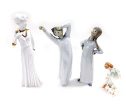 A Lladro porcelain figure of a boy in a night shirt, modelled yawning, another of a girl with her ha