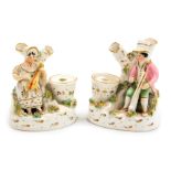 A pair of late 19thC Staffordshire pottery inkwells, modelled with a seated man playing a harp, a la