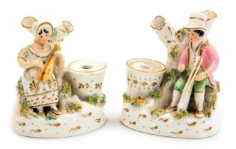 A pair of late 19thC Staffordshire pottery inkwells, modelled with a seated man playing a harp, a la