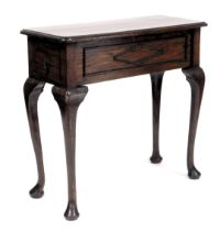 A Victorian oak side table, with a side frieze drawer, raised on cabriole legs, 80cm high, 85cm wide