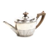 A Victorian silver semi fluted teapot, crest engraved, Henry Holland, London 1879, 10.81oz.