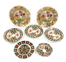 A group of Royal Crown Derby Imari porcelain plates, some seconds, comprising a pair of Imari Garden