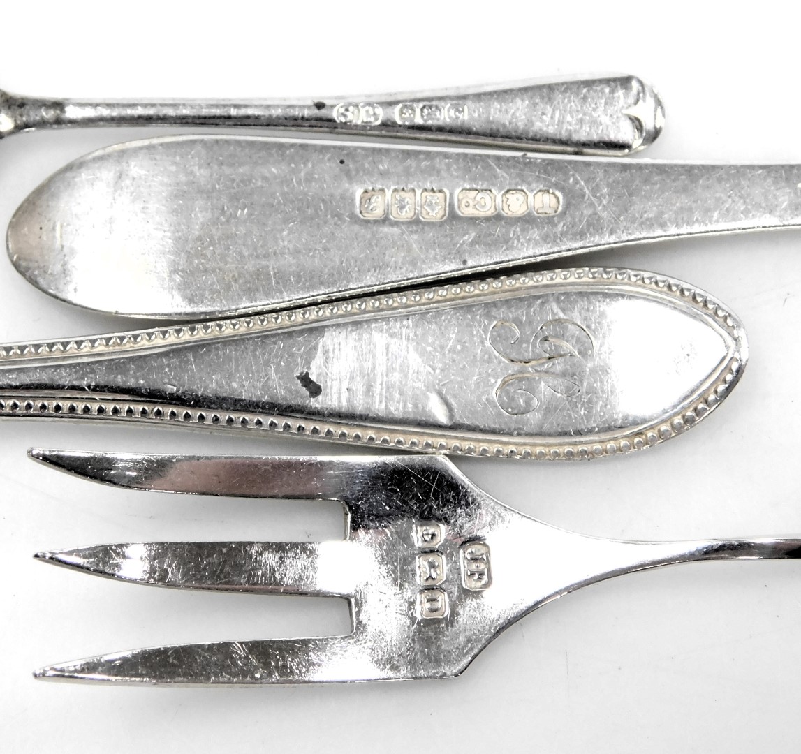 A pair of George V silver sugar tongs, Birmingham 1931, two silver napkin rings, a butter knife, pai - Image 2 of 4