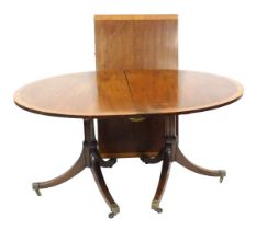 A Georgian style mahogany and yew wood cross banded oval twin pedestal dining table, with one additi