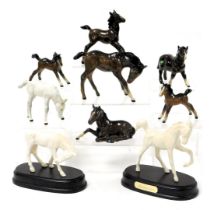 A group of Beswick pottery foals, in brown gloss and white. (9)